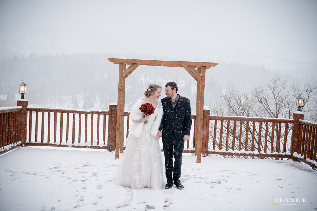 Timber Moose Lodge deck covered in snow with the bride and groom