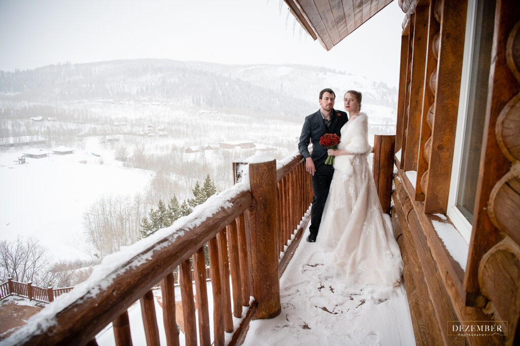 Timber Moose Lodge Wedding bride and groom on the patio with snow covered mountains in the background