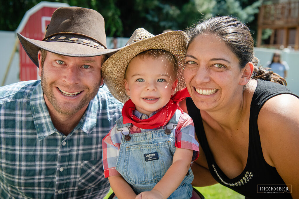 Birthday boy and his parents smile