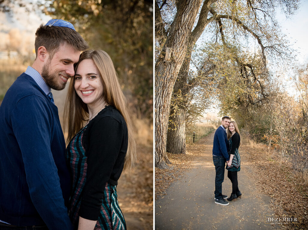 Couple smiles in park under trees