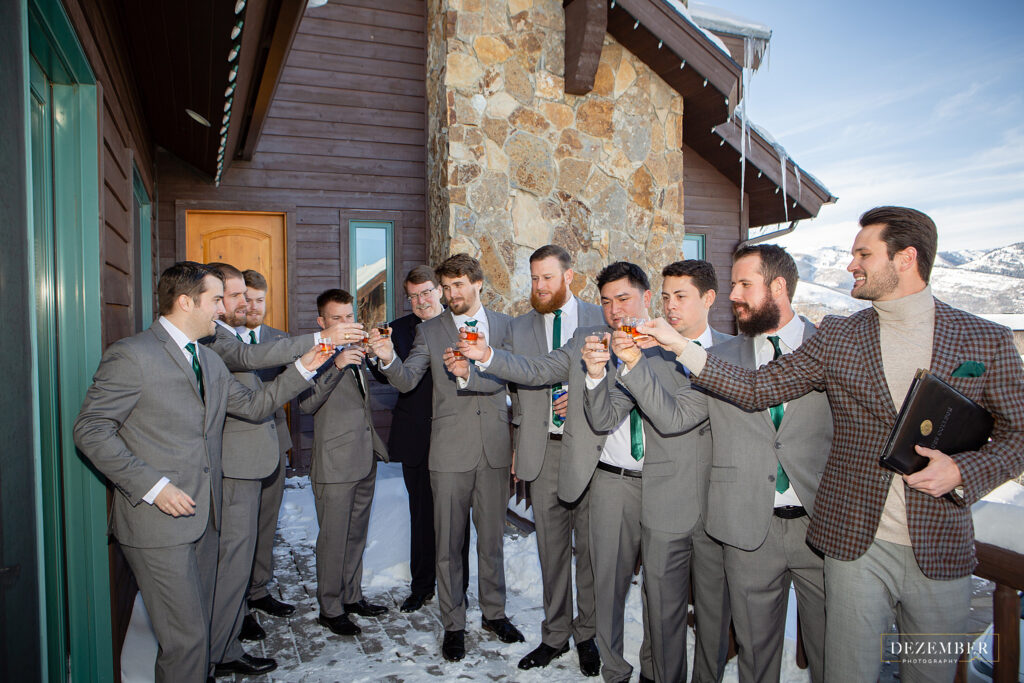 Montage Winter Wedding the groomsmen have a shot on the deck