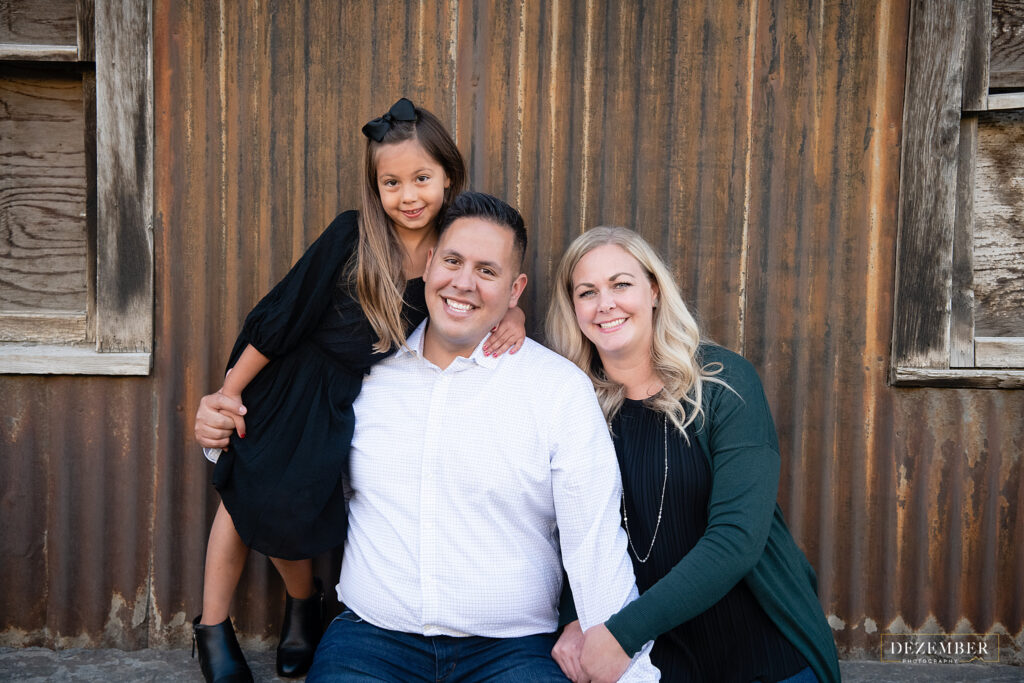 Family Portraits in front of corrugated metal wall