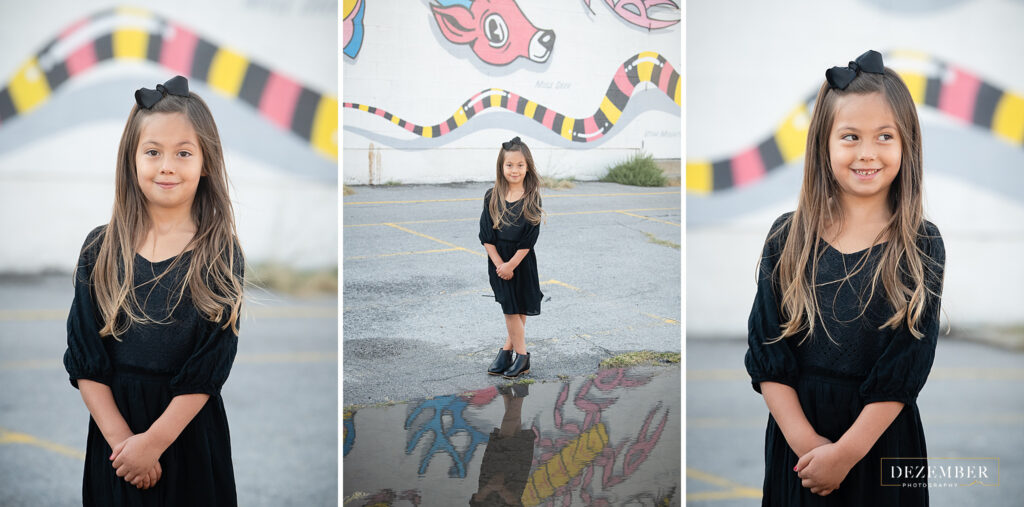 Girl in black dress portraits in front of mural