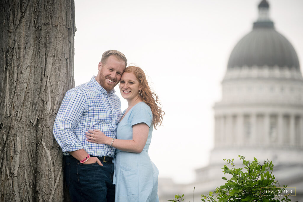 Utah Capitol Engagements couple poses with capitol building in the background
