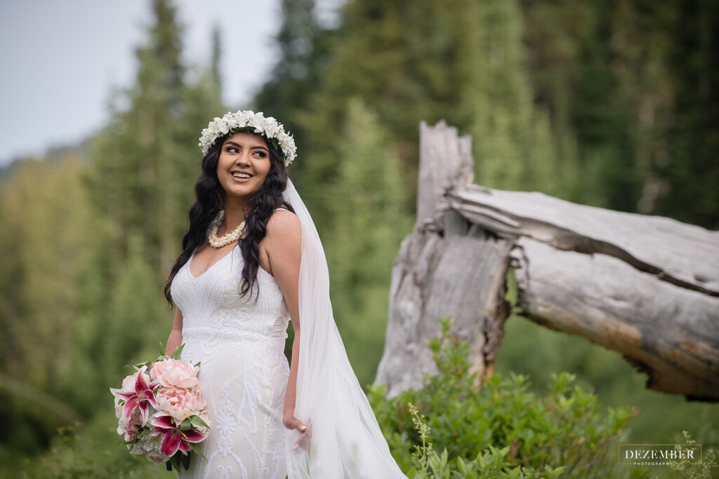 Bride smiles and looks at groom off screen