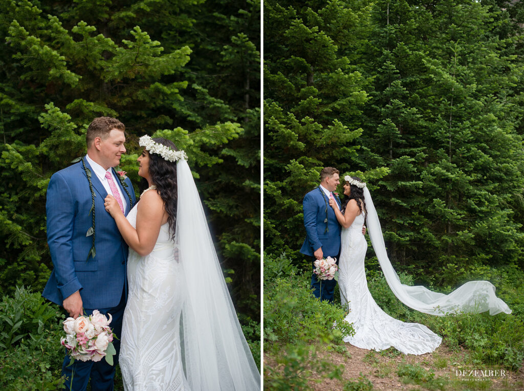 Couple poses in big evergreen trees