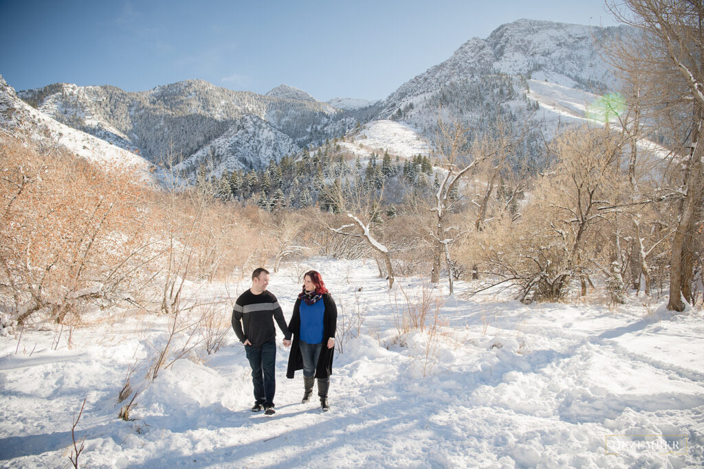 Snow portraits couple walks through trees