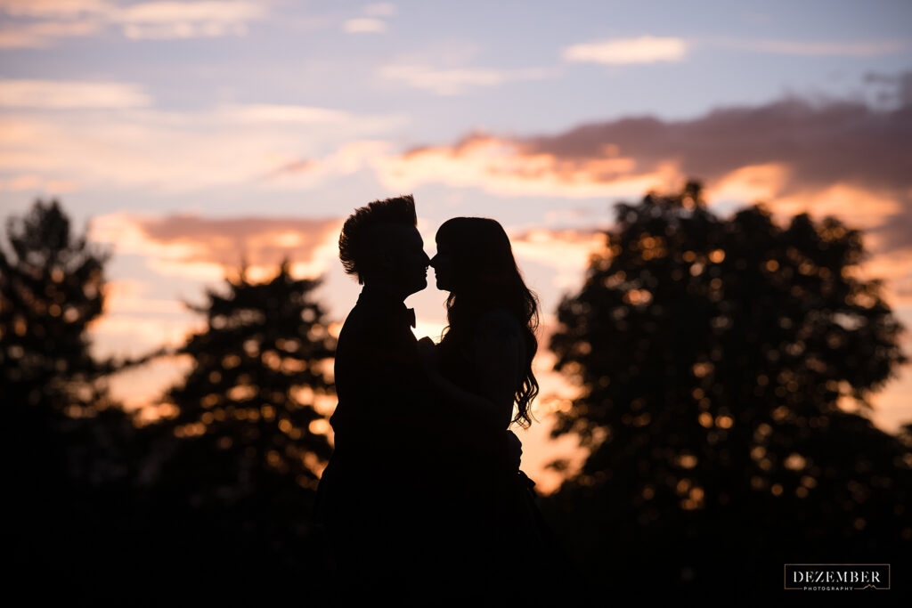 Sunset silhouette of bride and groom