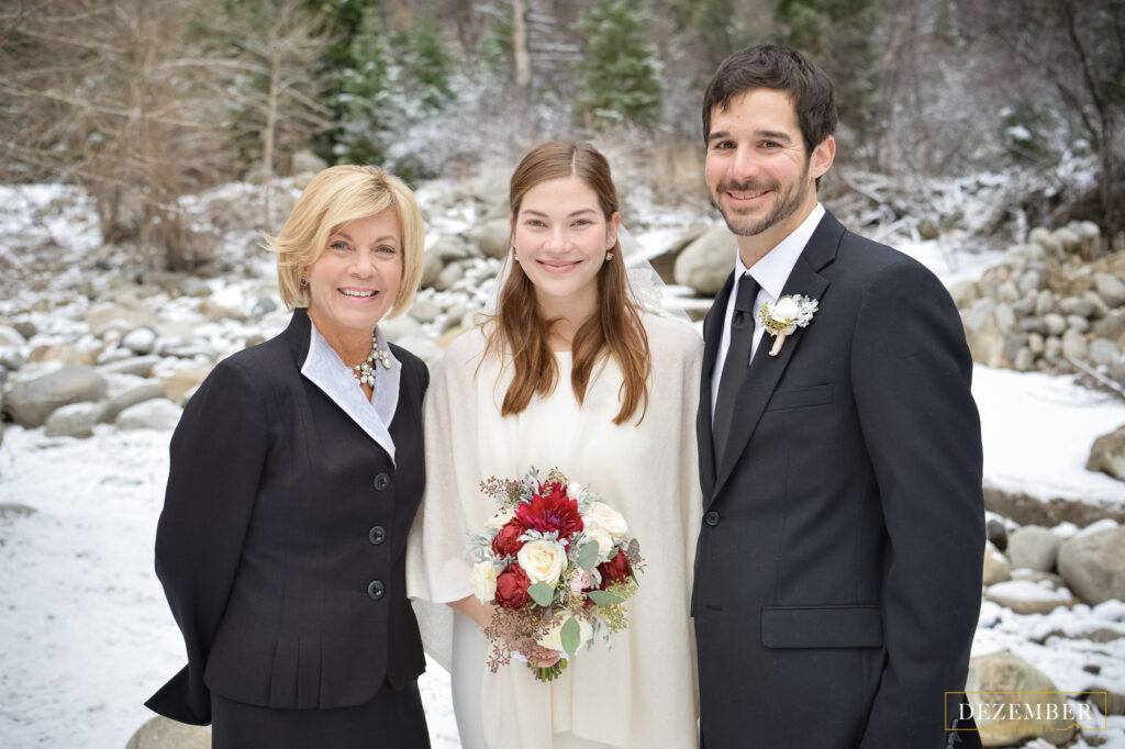 Bride and Groom smile with Officiant Anita