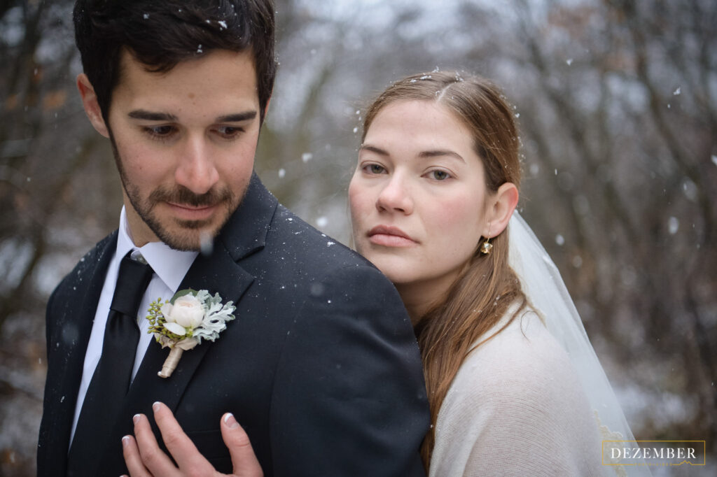 Bride hugs groom and looks at camera