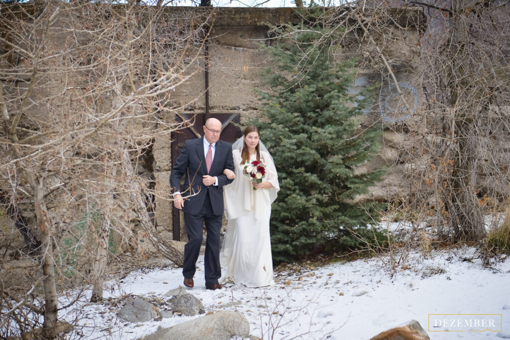 Father and bride walk to altar