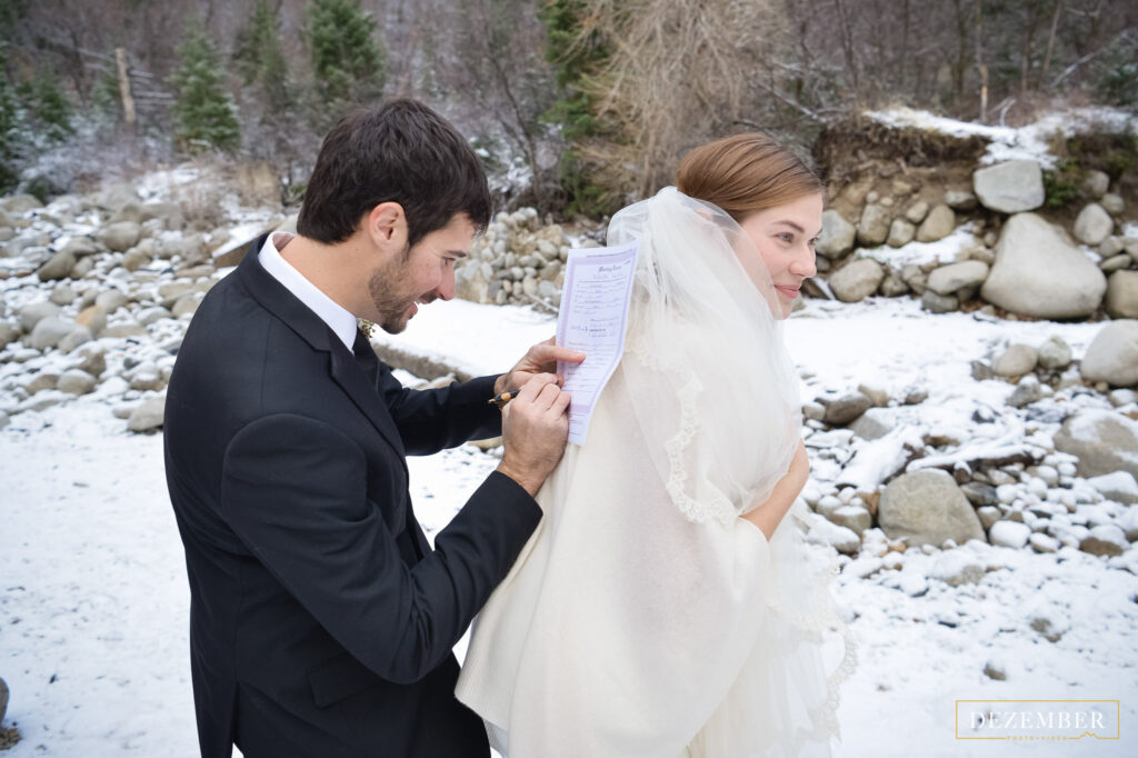 Groom signs marriage license