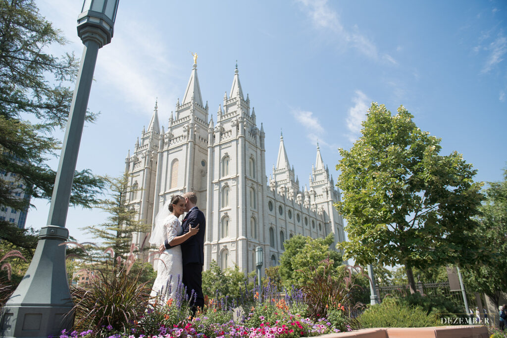 Wide shot of Salt Lake Temple with Bride and Groom