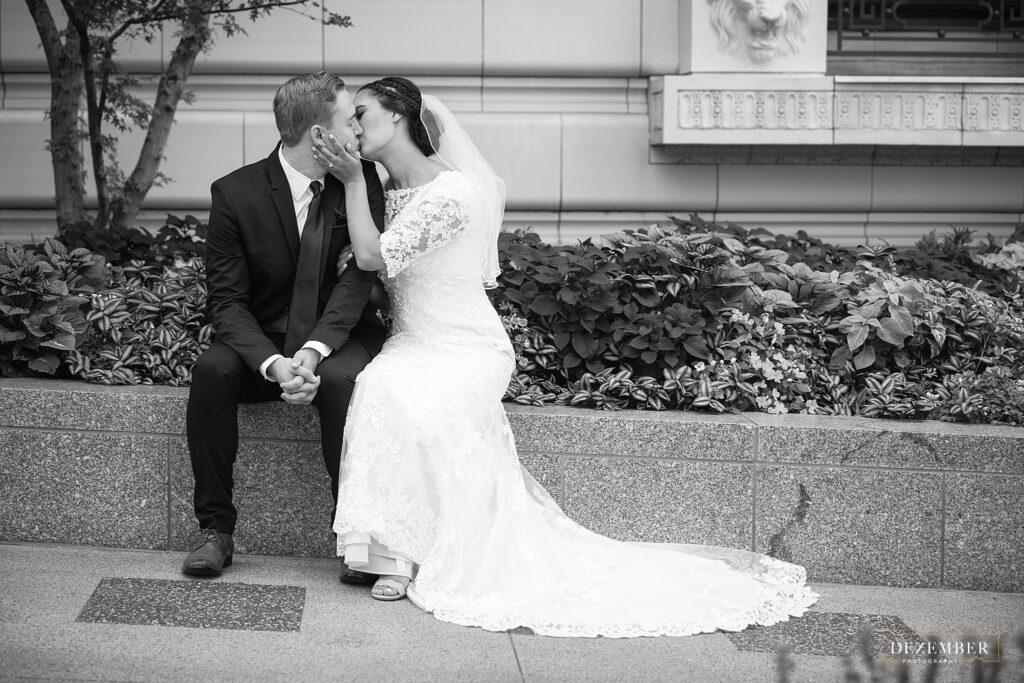 Newlyweds kiss black and white