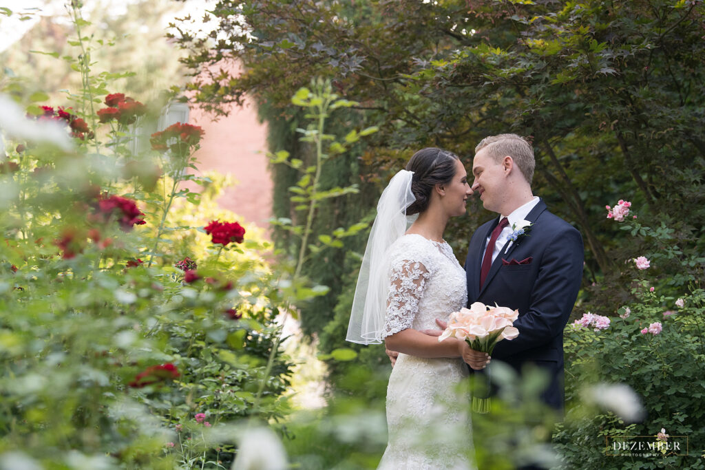 Newlyweds in rose garden at Ivy House
